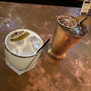 a glass of lemonade and a copper cup