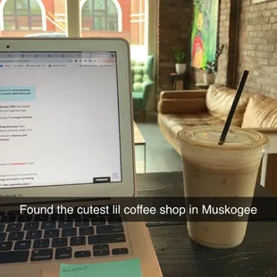 a cup of coffee next to a laptop