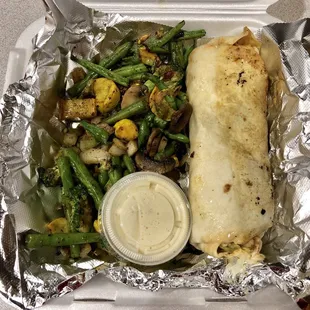 Chicken/shrimp, bacon and ranch wrap with grilled vegetables as well as a side of Alfredo sauce.