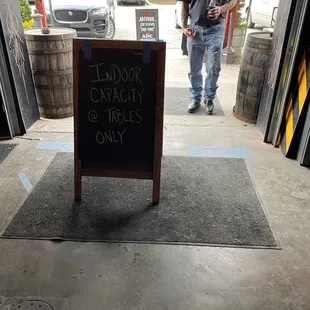 a man standing in front of a sign