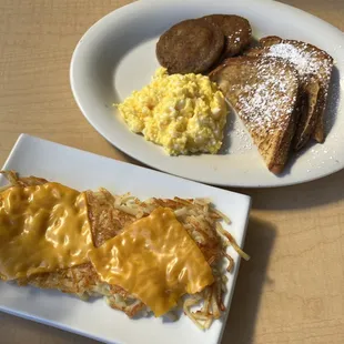 French toast with scrambled eggs &amp; sausage and a side of hash browns with cheese