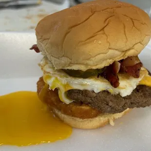 Bacon Cheese Burger with a Sunnyside up Egg and Hash Brown