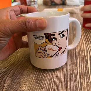 a person holding a cup of coffee