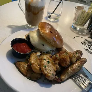 Breakfast sandwich: turkey sausage, egg, cheese, and roasted potatoes on the side. Delicious