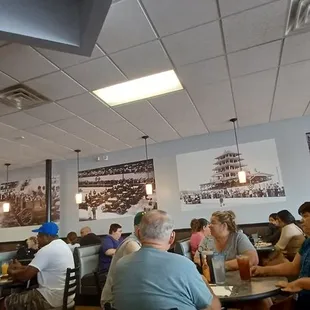 people sitting at tables in a restaurant