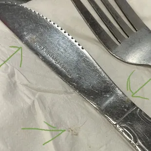 You can see the food on the knife and on the napkin. It was stuck to the napkin. This was given to me this way.