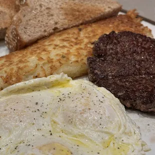 Burger patty, eggs, hashbrowns, toast