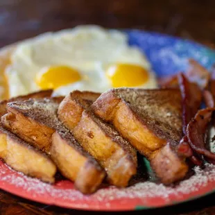 French Toast -4 texas toast triangles battered, lightly grilled &amp; sprinkled w/ powdered sugar &amp; served with 2 eggs and choice of meat