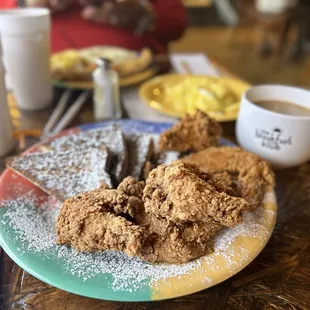 French toast, fried chicken wings, eggs and coffee.