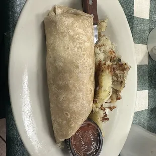 Sausage egg and cheese burrito with hash browns.