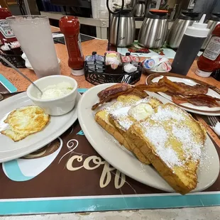 French toast plate with bacon . Add ons: bowl of grits, one fried egg, side of bacon