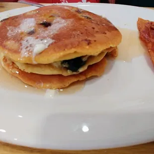 Blueberry pancakes and two pieces of bacon