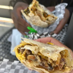 a person holding a burrito