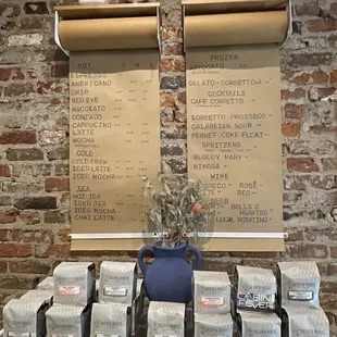 a brick wall with a display of coffee bags