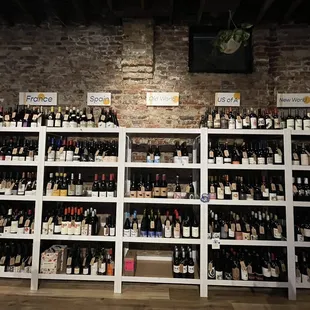 a wall of wine bottles in a wine shop