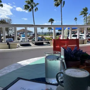 a cup of cappuccino and a menu