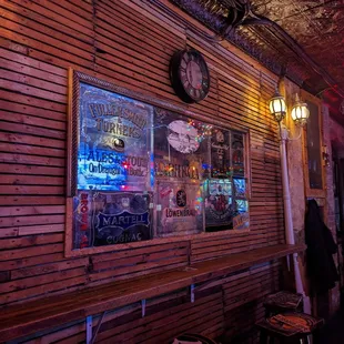 a bar with wooden walls and a clock on the wall