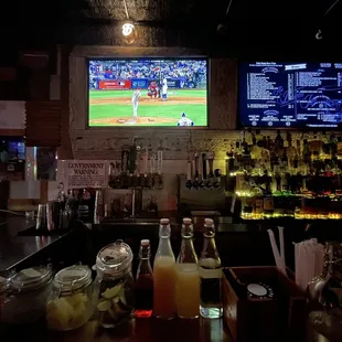 a baseball game being played on tvs