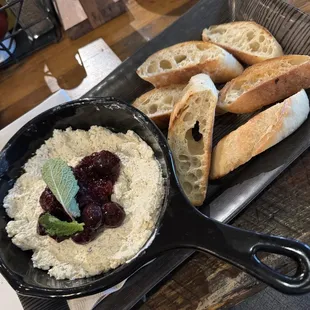 a bowl of hummusle and bread
