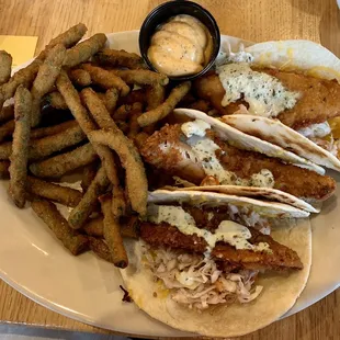 a plate of fish tacos and fries