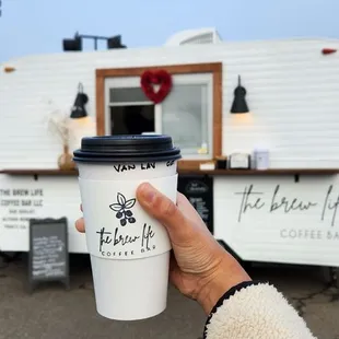 a person holding a cup of coffee