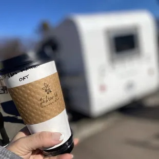 a person holding a cup of coffee