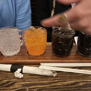 Flight of house made sodas (with our servers hand in the pack as she explains the different flavors she brought us)