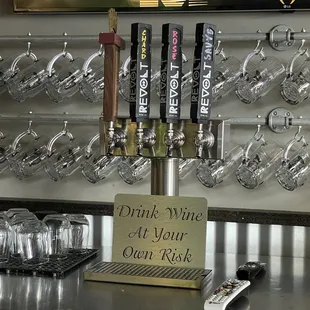 a beer tap with a sign that reads drink white at your own bar