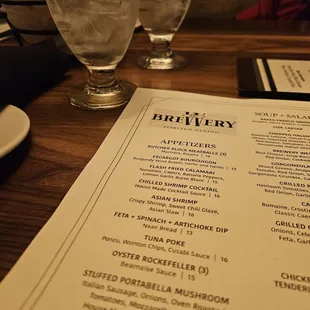 a menu and glasses on a table