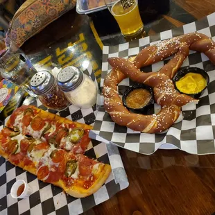 Partially eaten spicy pepperoni and giant soft pretzel (with mustard, but wish it waa cheese!)
