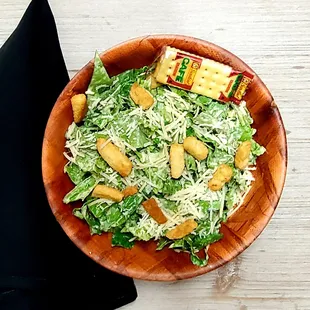 a bowl of salad and crackers