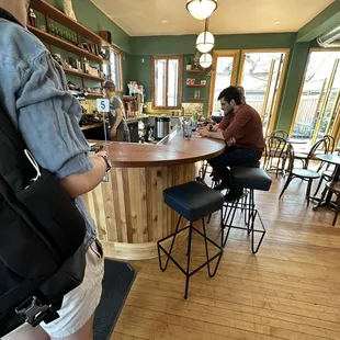 a man and a woman sitting at a bar
