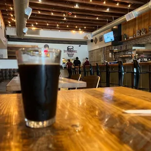 a pint of beer on a wooden table