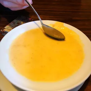 a bowl of soup with a spoon in it