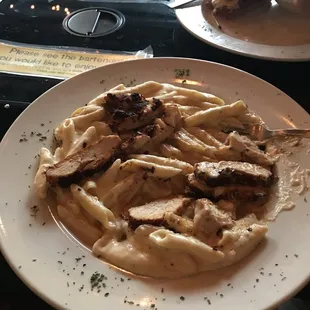 a plate of pasta and meat