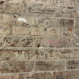 Love the signed brick wall