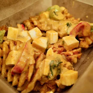 Panang curry poutine. Seasoned waffle cut fries with lots of cheese!