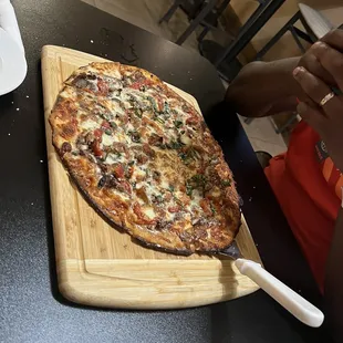 a pizza on a cutting board
