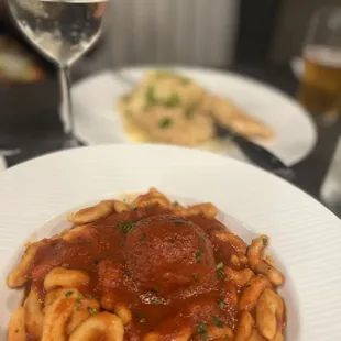 a plate of pasta and a glass of wine