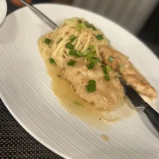 a plate of chicken and noodles