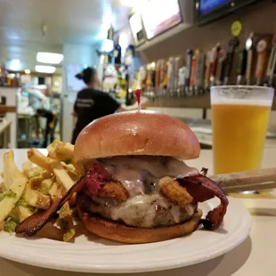 Pastrami burger with bacon and fried jalapenos! Side of garlic fries and a Fort Rock Pilsner : ) you can see the 30 beer taps in the back.