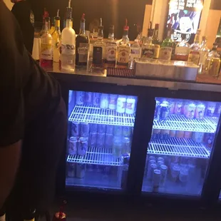 a man standing in front of a bar
