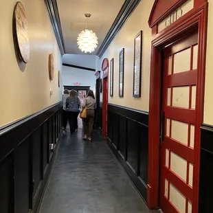hallway to back bar - bathroom doors are decorated like British phone booths!