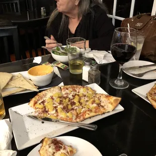 Half order of the Hawaiian pizza. In the background you can see the beer cheese with HUGE pita slices.
