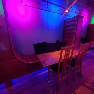 a dining table and chairs in a brightly lit room