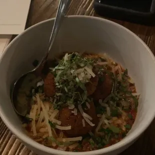 a bowl of pasta and meatballs