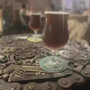 two glasses of beer on a table