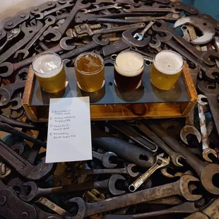 a variety of beer glasses and wrenches