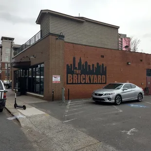 a car parked in front of a brick building