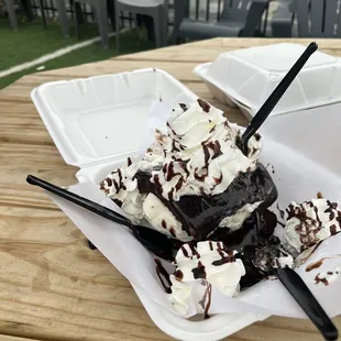a chocolate sundae with whipped cream and chocolate sauce